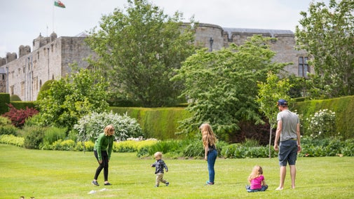 A family playing in the garden at Chirk Castle, Wales, in summer